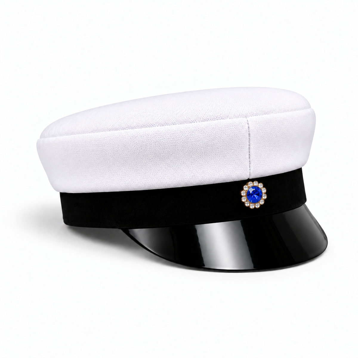 Swedish graduation cap with a white crown, black visor and blue-centred decorative badge, angled view