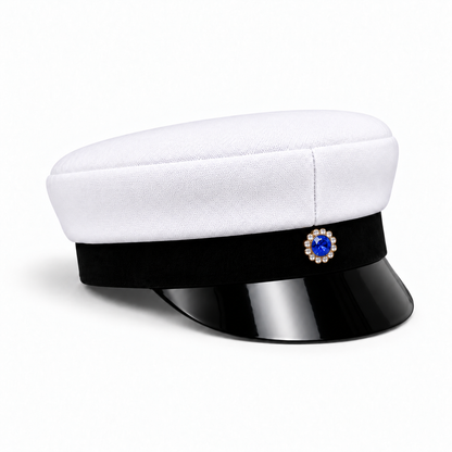 Swedish graduation cap with a white crown, black visor and blue-centred decorative badge, angled view
